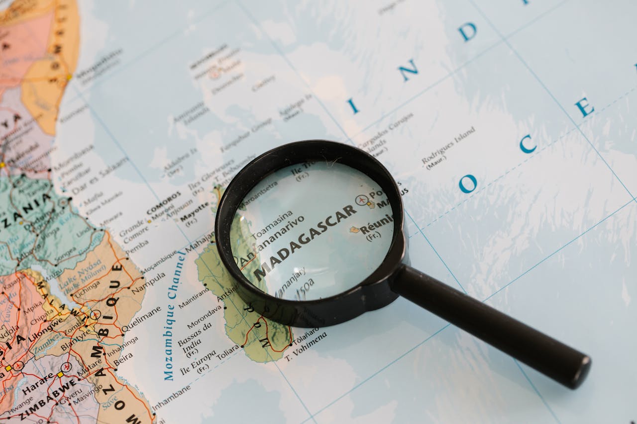 Home Close-up of Madagascar on a map with a magnifying glass highlighting the area.